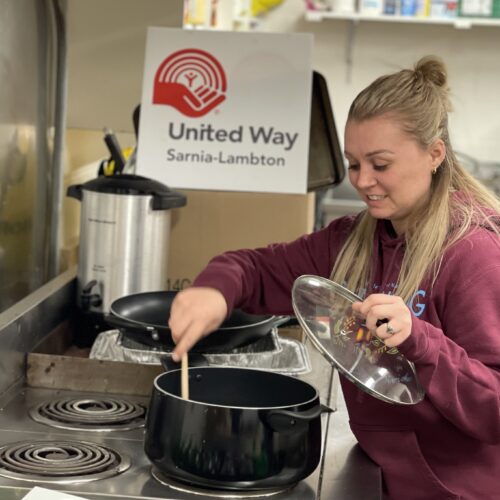 Woman cooking in united way kitchen